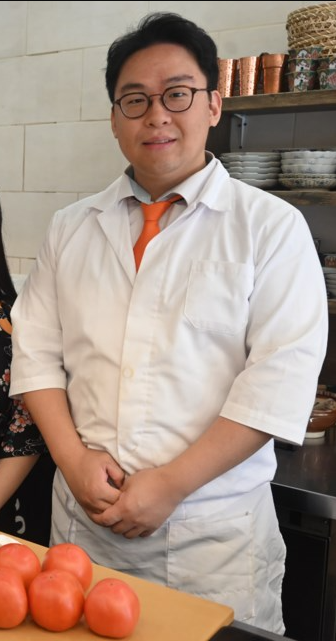Chef Minho Lee at the counter
